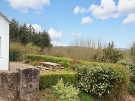 An outdoor area with a picnic table and shrubs at Turraheen in Cashel