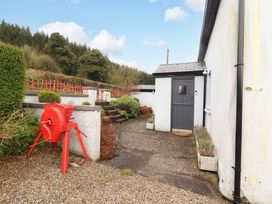 An outdoor path leading to a door with a garden feature at Turraheen in Cashel