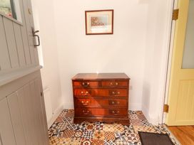 A hallway with a dresser and artwork on the wall at Artist’s Cottage in Cashel, County Tipperary
