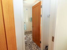 A bathroom with shower, toilet, and tiled floor at Artist’s Cottage, Cashel, County Tipperary