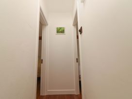 A hallway with doors and a picture on the wall at Artist’s Cottage in Cashel, County Tipperary
