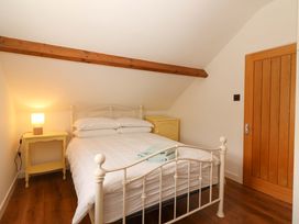 A bedroom with a bed and bedside table at Artist’s Cottage, Cashel, County Tipperary