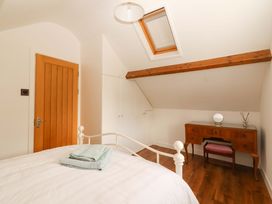 A bedroom with a bed and desk at Artist’s Cottage, Cashel, County Tipperary