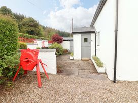 An outdoor area with a red decoration and a door at Artist’s Cottage in Cashel, County Tipperary