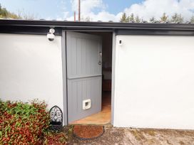 An entrance with a gray door and welcome mat at Artist’s Cottage, Cashel, County Tipperary
