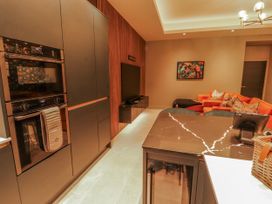 A kitchen with black cabinets and appliances at Bounty Boutique on the Lakes Bowness-On-Windermere