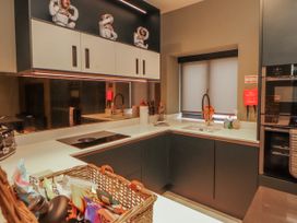 A kitchen with cabinets, sink, stove and utensils at Bounty Boutique on the Lakes Bowness-On-Windermere