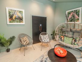 A seating area with two chairs and a swing chair at Bounty Boutique on the Lakes Bowness-On-Windermere