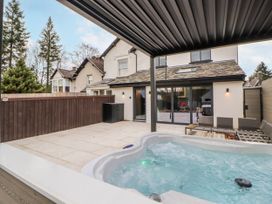 An outdoor area with a hot tub and seating at Bounty Boutique on the Lakes in Bowness-On-Windermere
