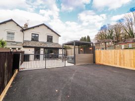 An outdoor area with a carport and hot tub at Bounty Boutique on the Lakes Bowness-On-Windermere