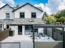 A house with a patio and hot tub at Bounty Boutique on the Lakes Bowness-On-Windermere