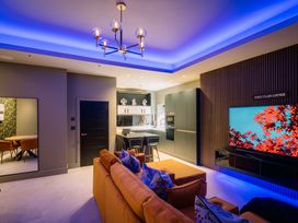 A living room with a television and sofa at Bounty Boutique on the Lakes Bowness-On-Windermere