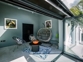 A sunroom with seating and artwork at Bounty Boutique on the Lakes in Bowness-On-Windermere