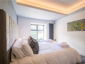 A bedroom with a bed and window at Bounty Boutique on the Lakes in Bowness-On-Windermere