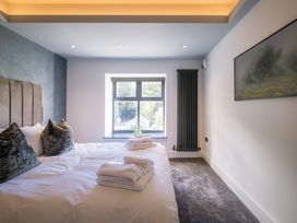 A bedroom with a bed and window at Bounty Boutique on the Lakes Bowness-On-Windermere