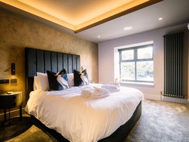 A bedroom with a bed and window at Bounty Boutique on the Lakes Bowness-On-Windermere