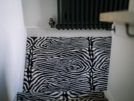 A staircase with a zebra patterned rug and a radiator at Bounty Boutique on the Lakes Bowness-On-Windermere
