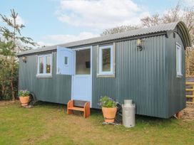 A shelter with blue door and windows set outside at Skye in Clee Hill