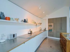 A kitchen with countertop and oven at Bredy Cottages in Burton Bradstock