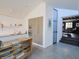 A kitchen with a sink and cabinets at Bredy Cottages in Burton Bradstock