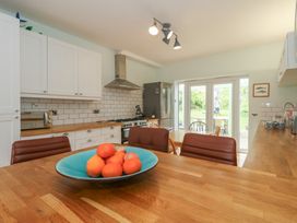 A kitchen with a bowl of oranges on the table at Millmead House in Portesham
