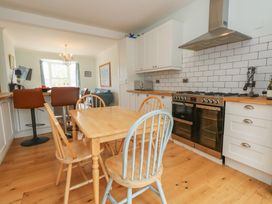 A kitchen with a dining table and chairs at Millmead House Portesham