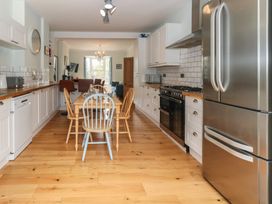 A kitchen with a dining table and chairs at Millmead House Portesham