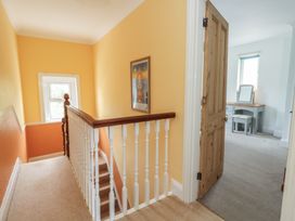 A hallway with stairs and a door leading to another room at Millmead House Portesham