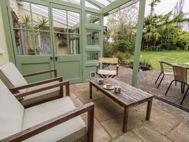 A conservatory with seating and a table at Millmead House Portesham