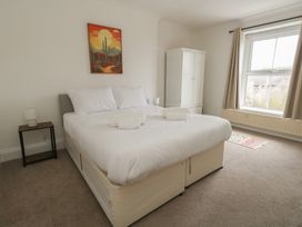 A bedroom with a bed and wardrobe at Millmead House, Portesham