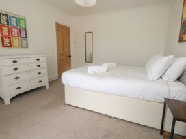 A bedroom with a bed and a drawer unit at Millmead House Portesham