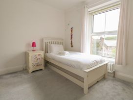 A bedroom with a single bed and a nightstand at Millmead House in Portesham