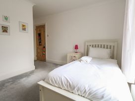 A bedroom with a bed and bedside table at Millmead House Portesham