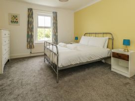 A bedroom with a bed and dresser at Millmead House Portesham