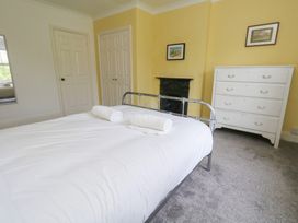 A bedroom with a bed and wardrobe at Millmead House in Portesham