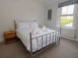 A bedroom with a bed and nightstand at Millmead House in Portesham