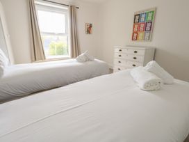 A bedroom with two beds and a dresser at Millmead House in Portesham