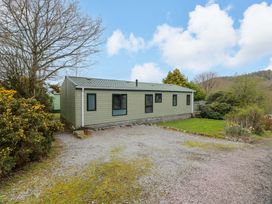 A mobile home with a gravel driveway at L21 Coastal Kippford Kippford near Sandyhills