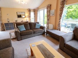 A living room with a sofa and coffee table at L21 Coastal Kippford in Kippford near Sandyhills