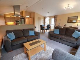A living room with sofas and a dining area at L21 Coastal Kippford Kippford near Sandyhills