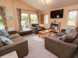 A living room with a television and fireplace at L21 Coastal Kippford in Kippford near Sandyhills