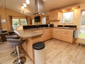 A kitchen with cabinets and counter space at L21 Coastal Kippford near Kippford