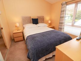 A bedroom with a bed and nightstands at L21 Coastal Kippford Kippford near Sandyhills
