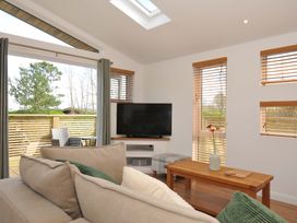 A living room with a sofa and television at 3 Faraway Fields in Dobwalls