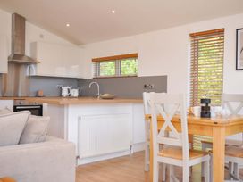 A kitchen with a dining table and chairs at 3 Faraway Fields in Dobwalls