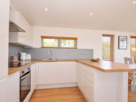 A kitchen with a sink and cooker at 3 Faraway Fields Dobwalls