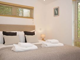 A bedroom with a bed and pillows at 3 Faraway Fields in Dobwalls