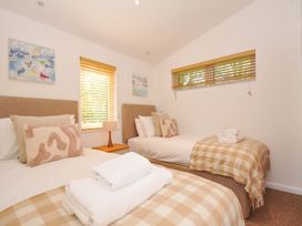 A bedroom with two beds and decorative artwork at 3 Faraway Fields in Dobwalls