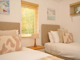 A bedroom with two beds and a lamp at 3 Faraway Fields in Dobwalls