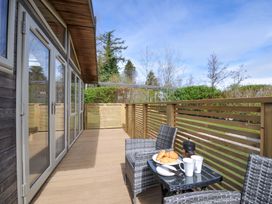 An outdoor area with a table and chairs containing coffee and croissants at 3 Faraway Fields in Dobwalls